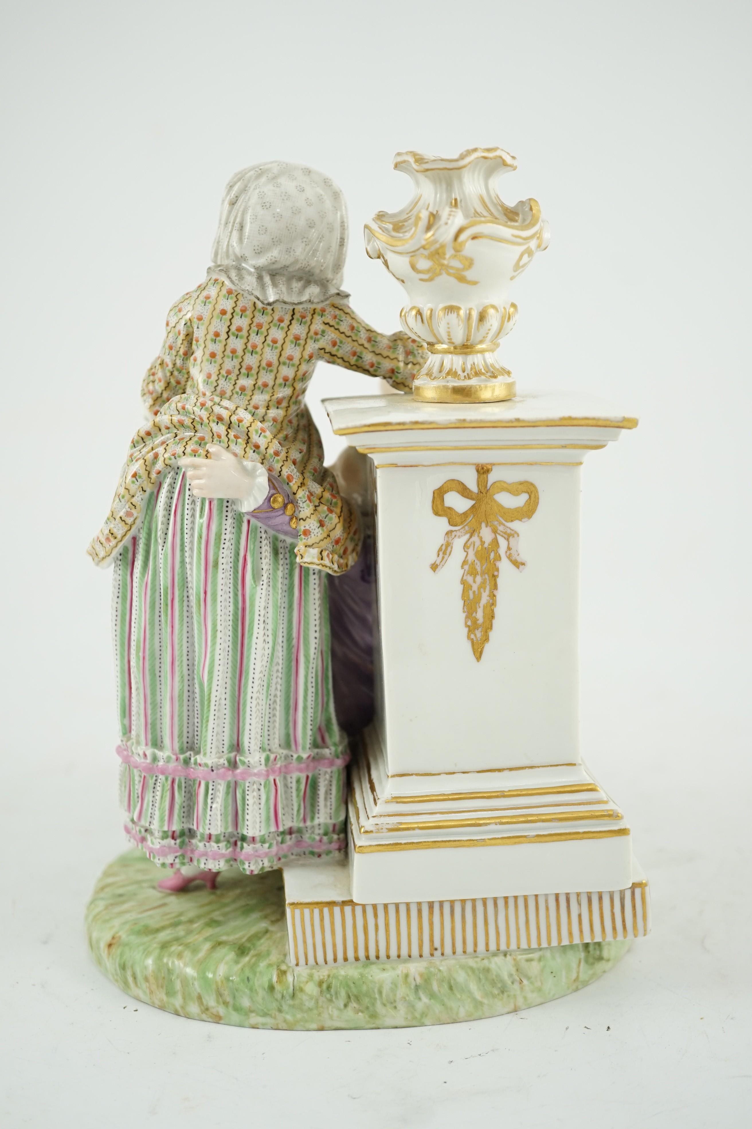 A Meissen porcelain group of a maid and a gallant by a pedestal, 19th century, 22cm high, crack to base